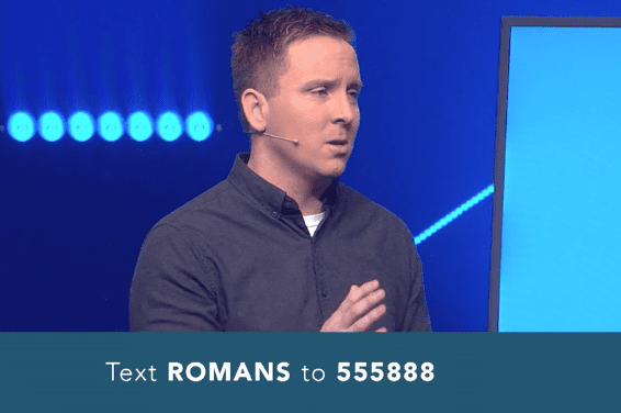 Pastor speaking with text message invitation for Romans reading plan