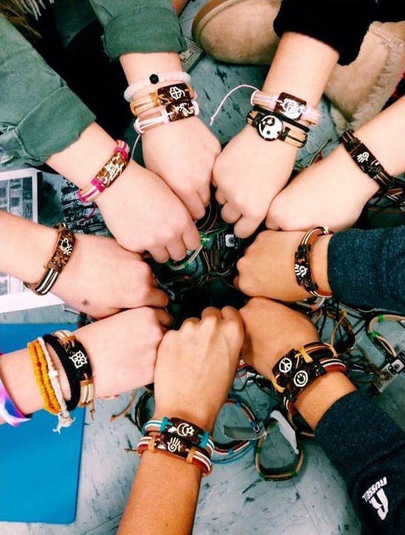Photo of nine different arms wearing Yuda Bands