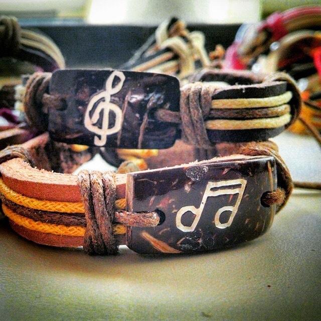 Two Yuda Bands stacked, one with a treble clef design and another with a musical note design