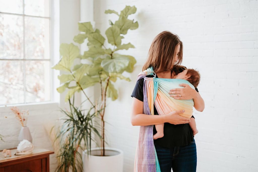 Mother holding child in Baby Tula carrier