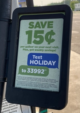 An ad posted on a gas pump line promoting Holiday Stationstores’ texting list that you can join by texting HOLIDAY to 33992.